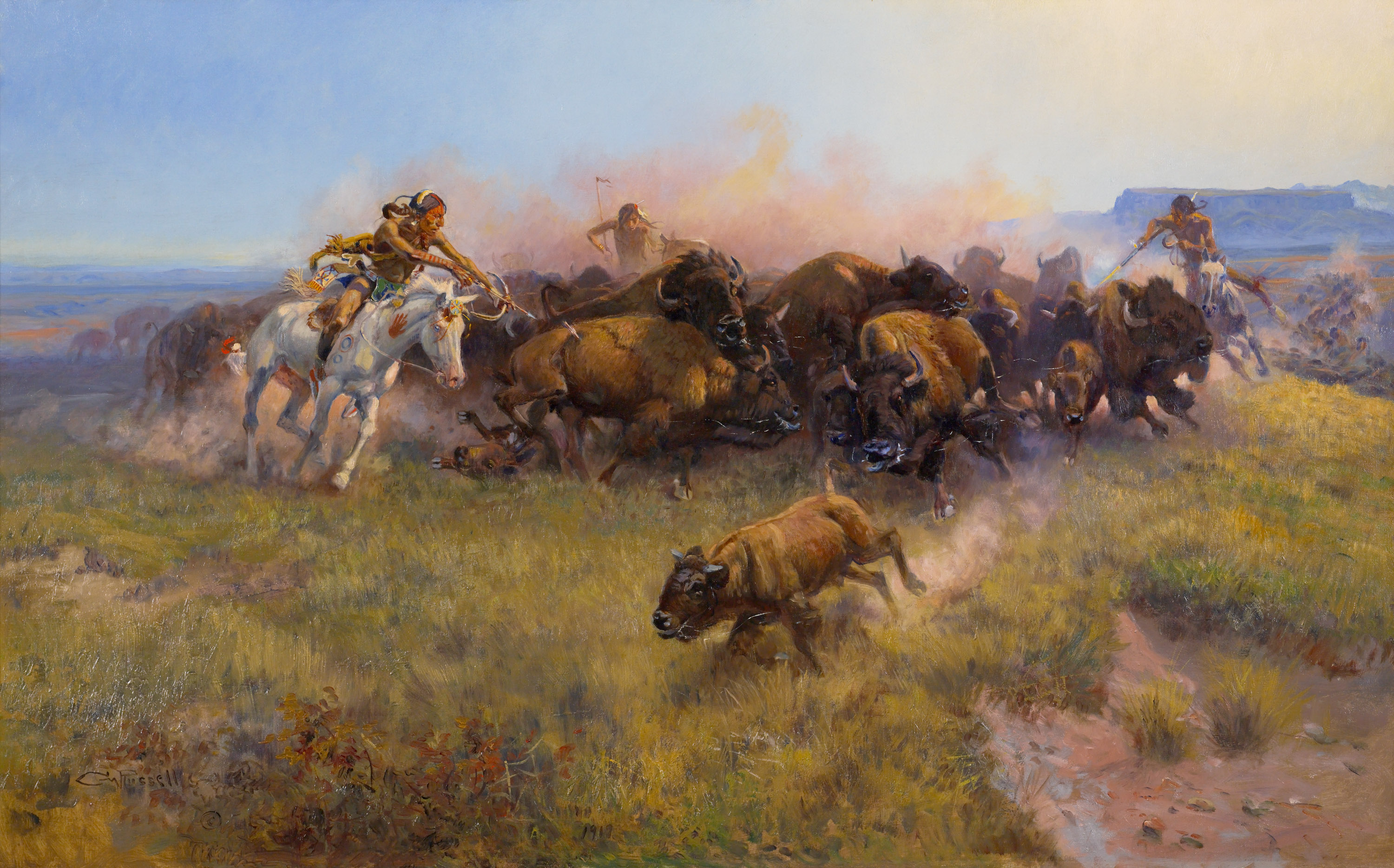 A dynamic oil painting of Native American men on horseback hunting a heard of bison.